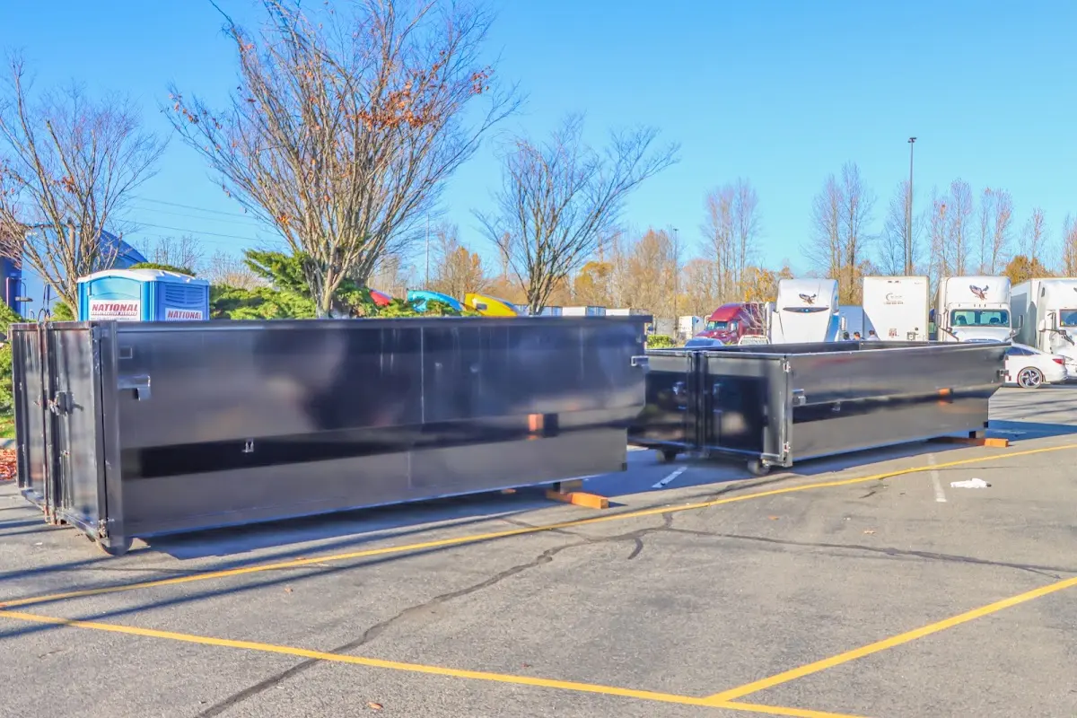 Professional dumpster rental service with roll-off container on residential driveway in Hull